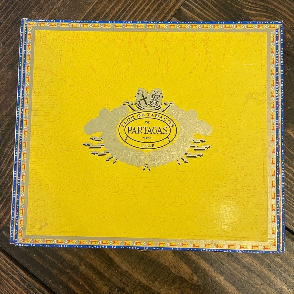 Vibrant Yellow and Blue Cigar Box with Decorative Emblem